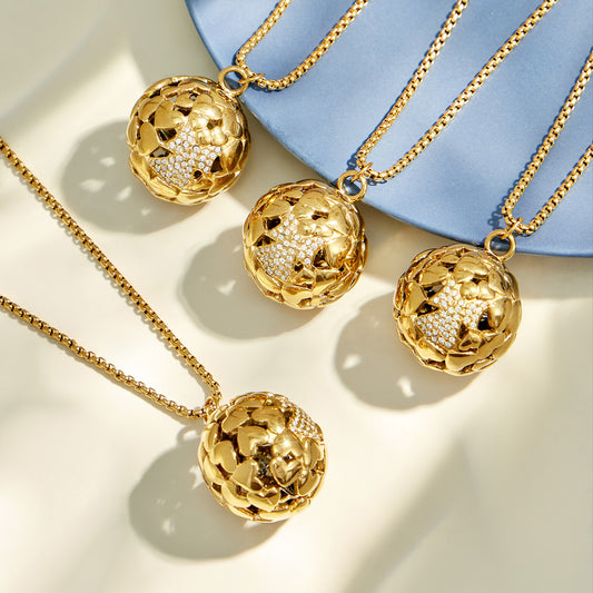 Gold and polished steel floral medallion pendant necklaces displayed with jewelry props