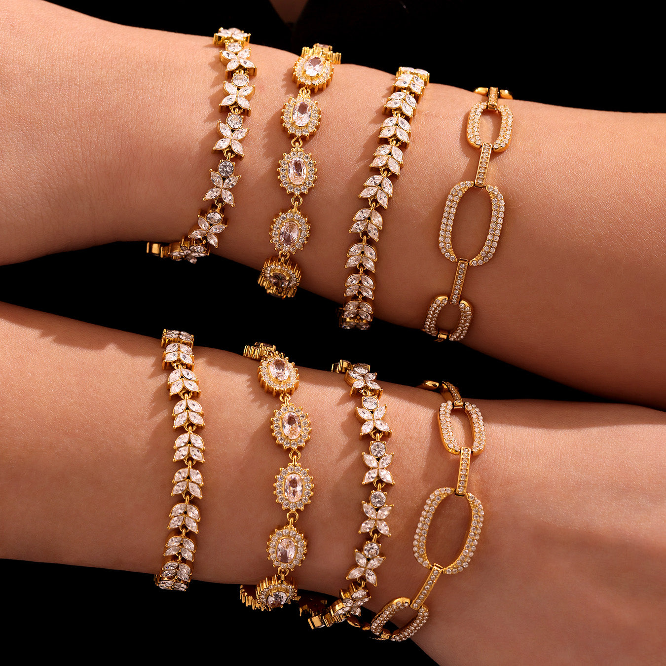 Gold zircon tennis, floral and link bracelets stacked on a model’s wrists