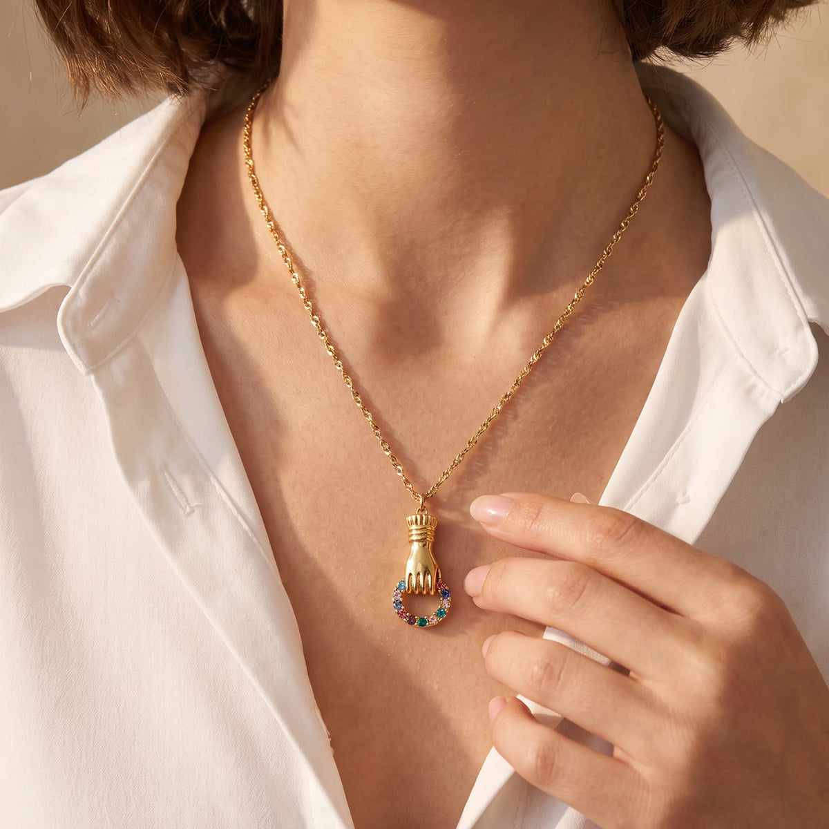Gold-tone stainless steel zircon pendant necklace worn on a model