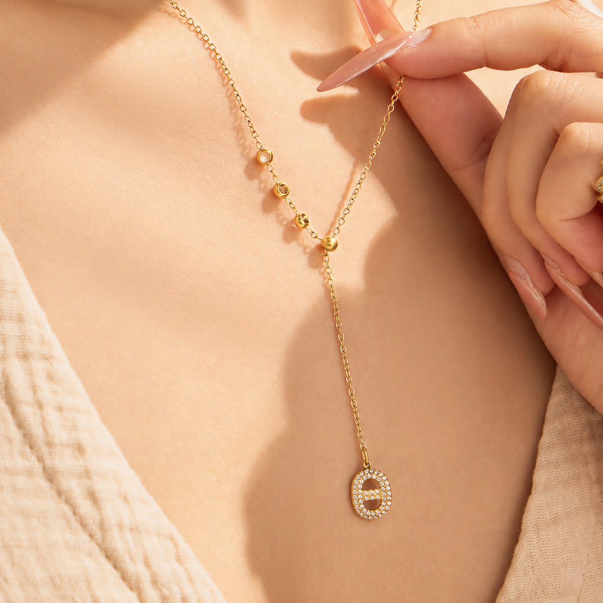 Gold-tone zircon Y necklace with vertical drop design worn on model
