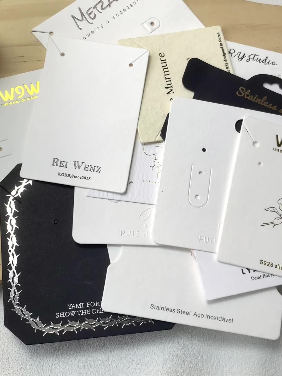 Assortment of black and white jewelry display cards for retail packaging