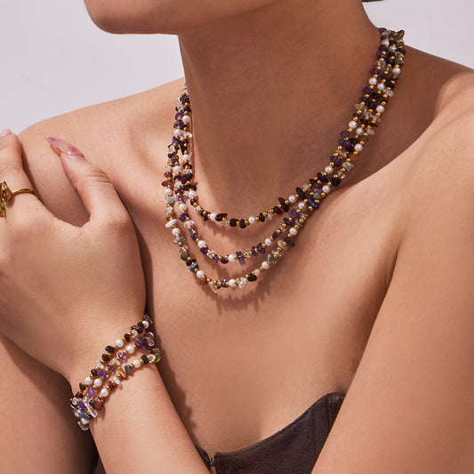 Model wearing a layered natural stone necklace with a coordinating beaded bracelet