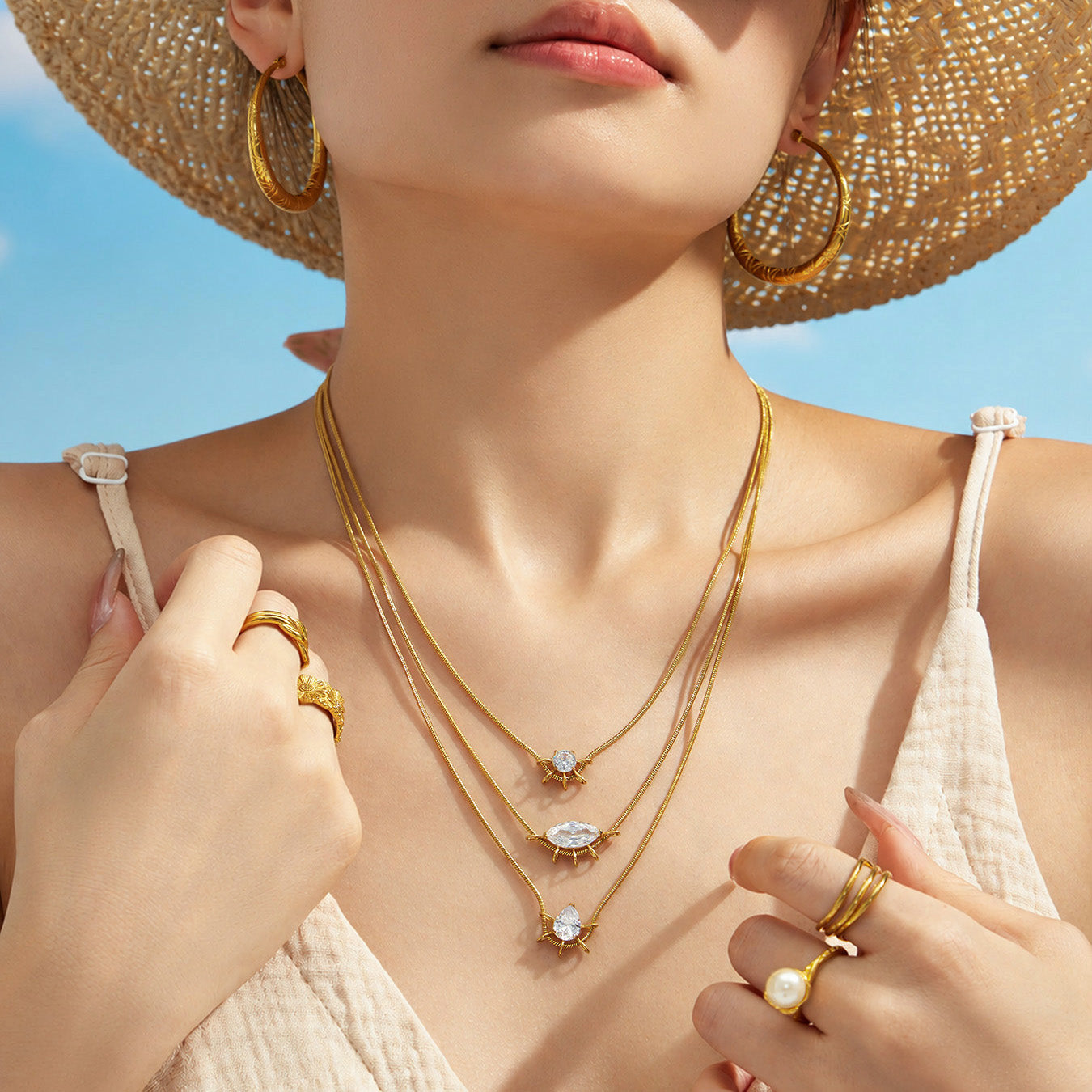 Summer model wearing layered geometric zircon pendant necklaces with a white outfit