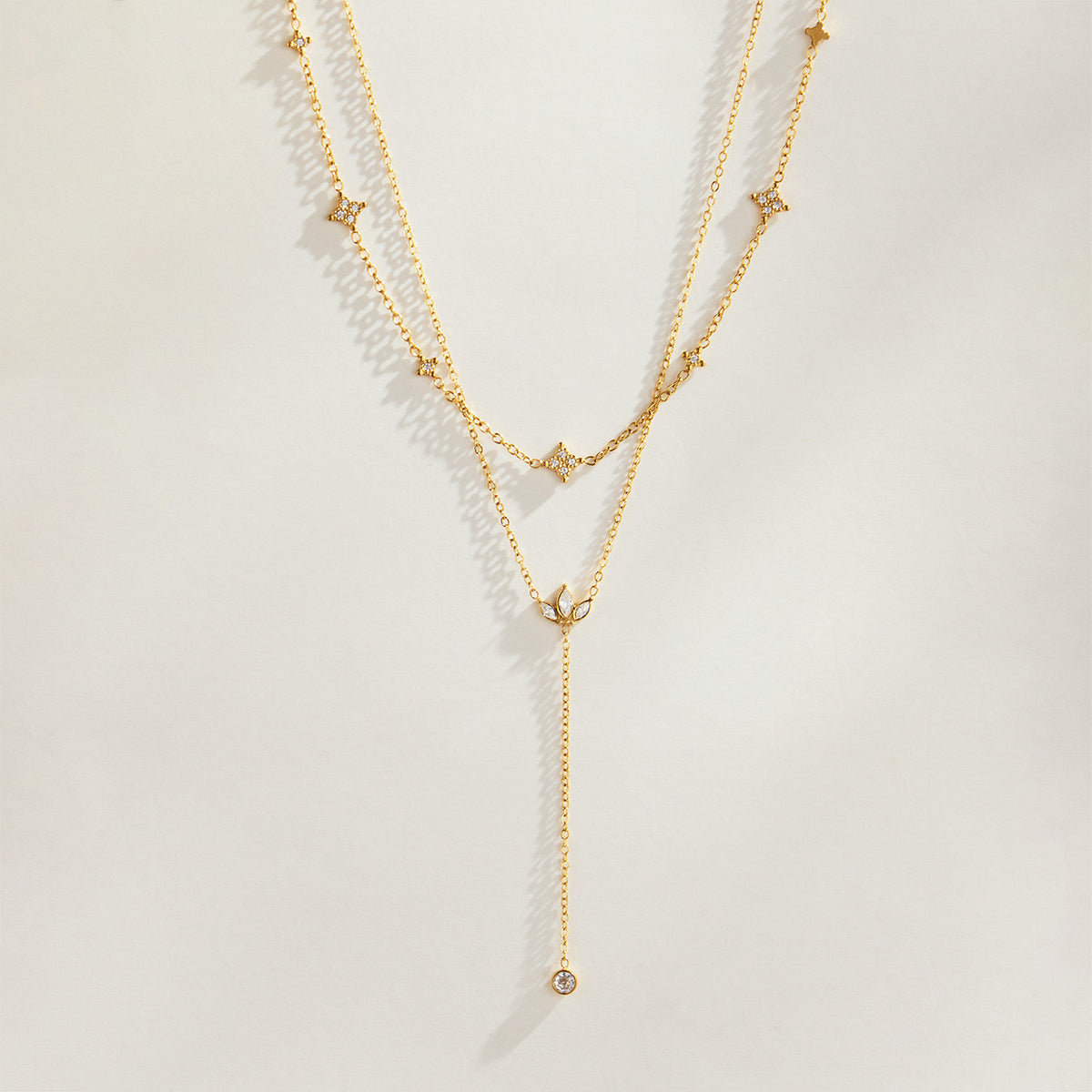 Layered gold PVD zircon necklaces with Y lariat pendant design