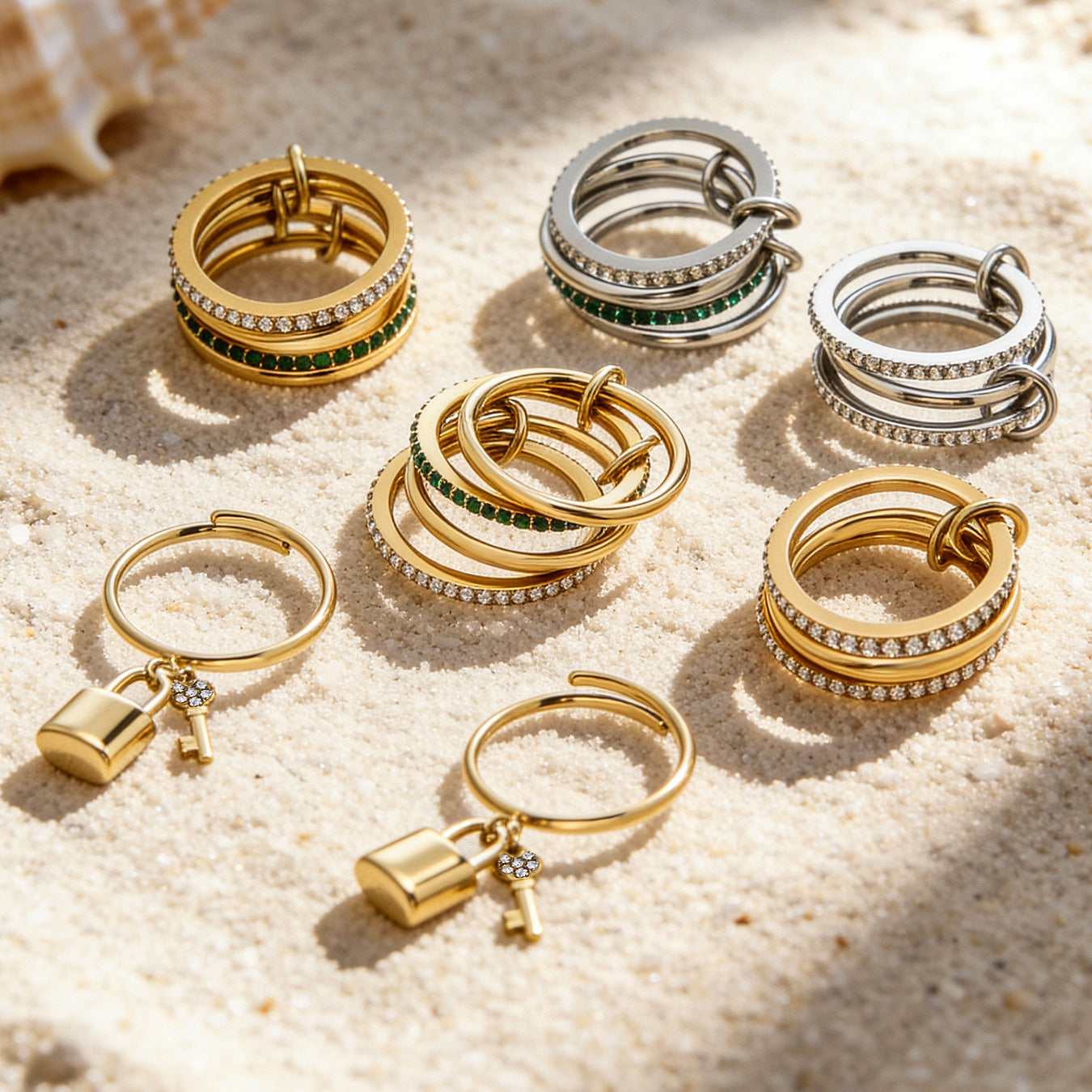 Gold and silver lock and key stacked rings with 5A zircon pave displayed in a flat lay