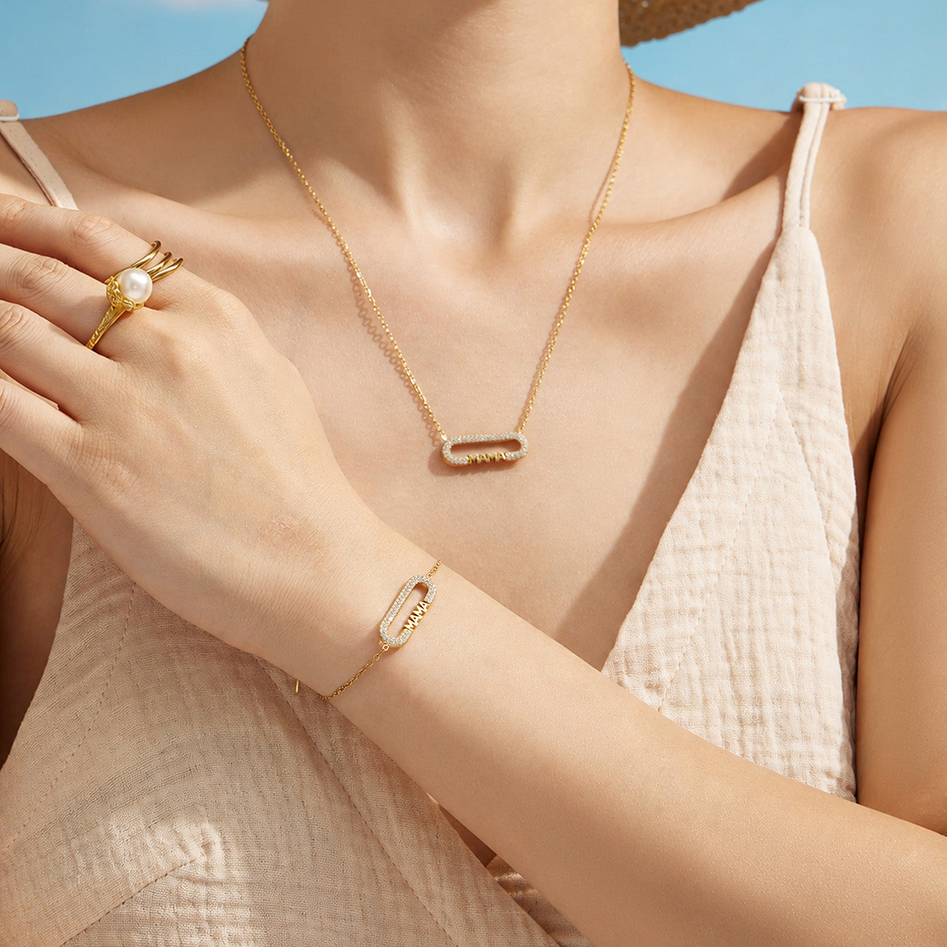 Model styling a gold MAMA zircon necklace with the matching letter bracelet
