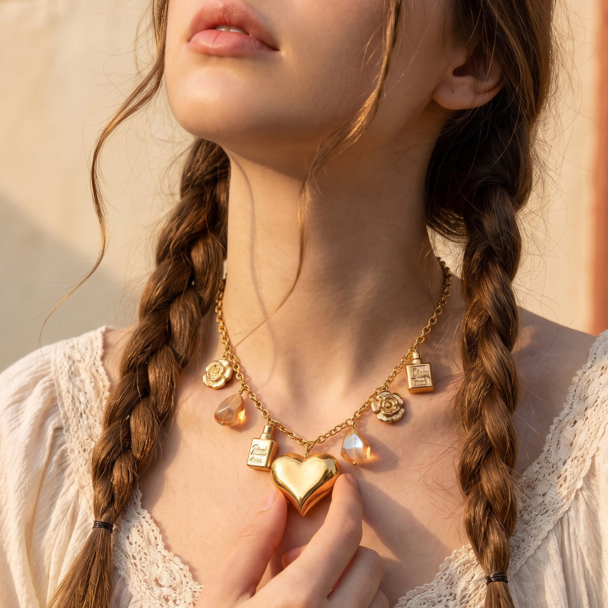 Multi-charm heart necklace with gold chain and warm resin accents worn on model