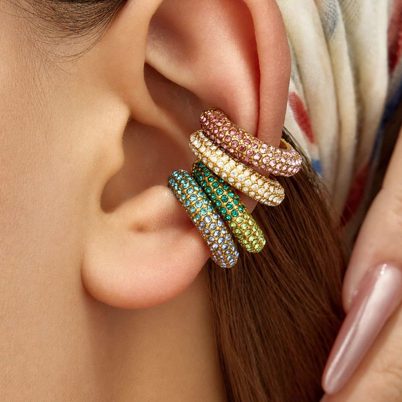 Colorful cubic zirconia no-piercing ear cuffs styled in a stacked ear look