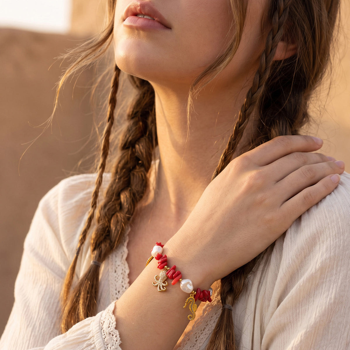 Ocean animal charm bracelet with red bead and sea life details worn on model