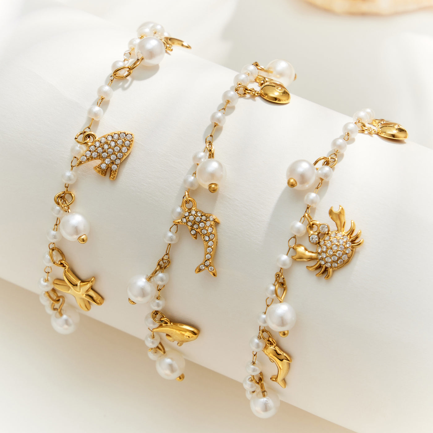 Gold marine charm pearl bracelet assortment with pearl beads and ocean-themed stainless steel charms