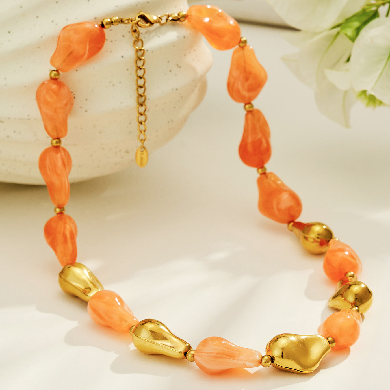 Orange resin necklace and matching bracelet set with organic chunky beads and gold-tone details