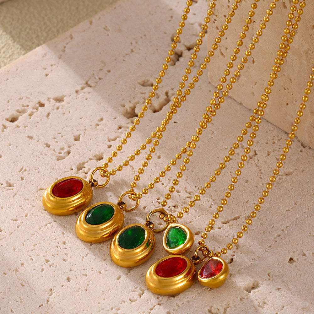 Red, green and mixed-color oval zircon pendant necklaces displayed together