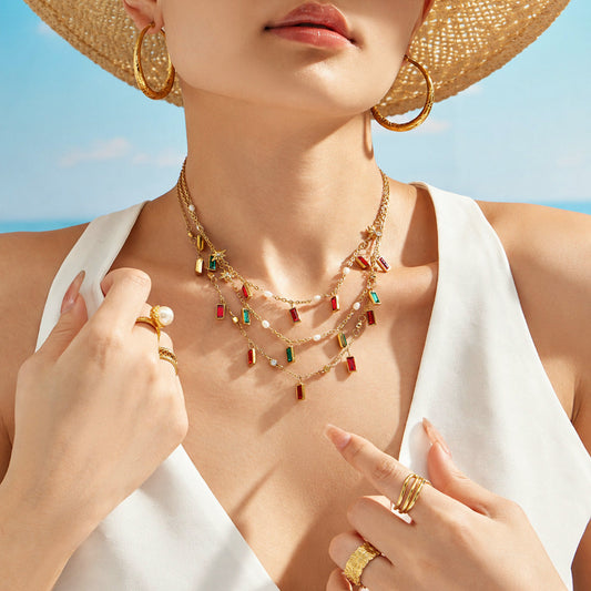 Model wearing colorful glass stone charm necklace in gold tone stainless steel for vacation jewelry styling