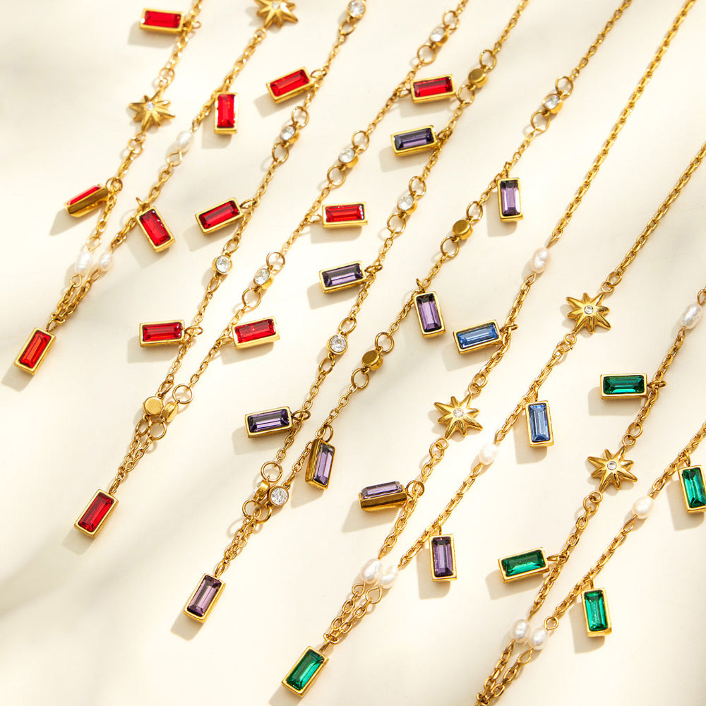 Colorful glass stone charm necklaces arranged for wholesale boutique jewelry display