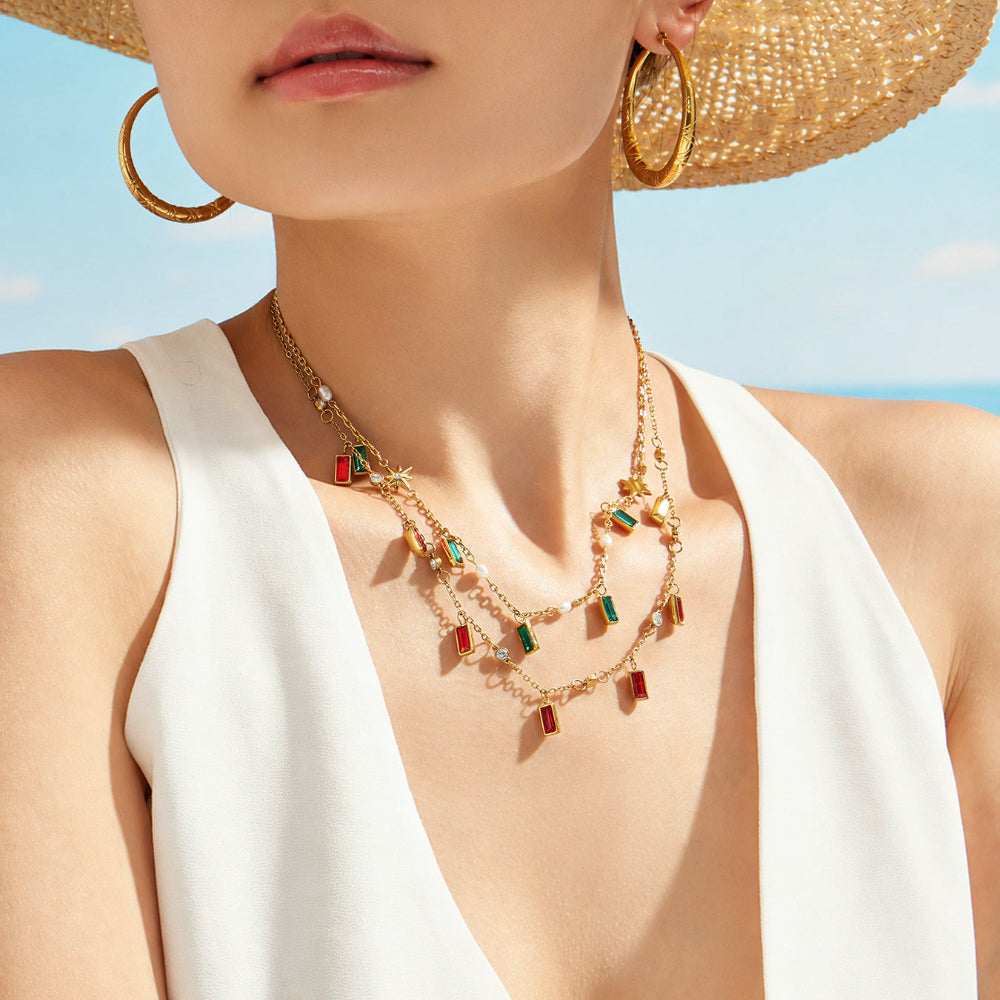Gold colorful glass stone necklace styled with white outfit for summer resort and boutique jewelry display