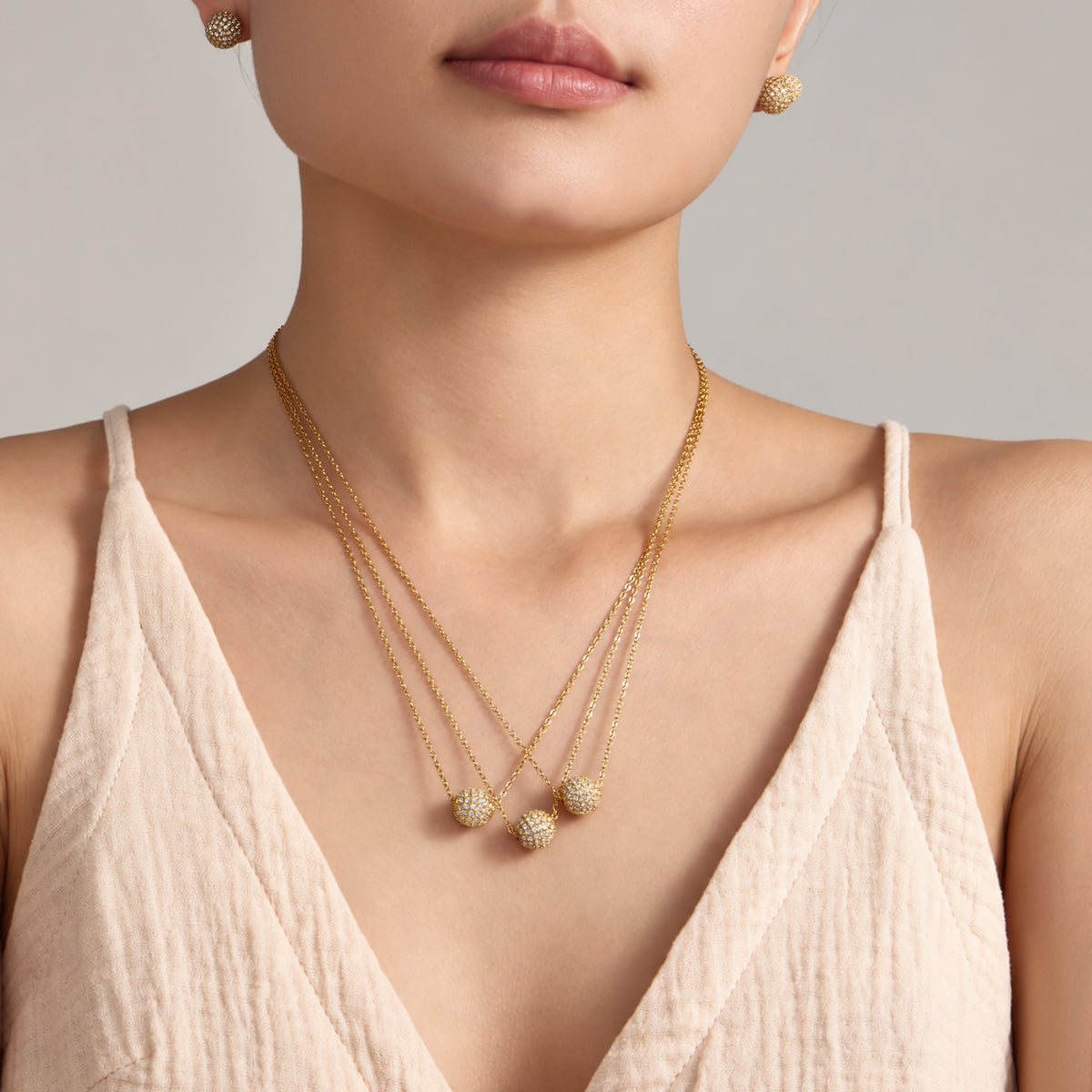 Pavé zircon ball necklace worn on model with gold-tone chain