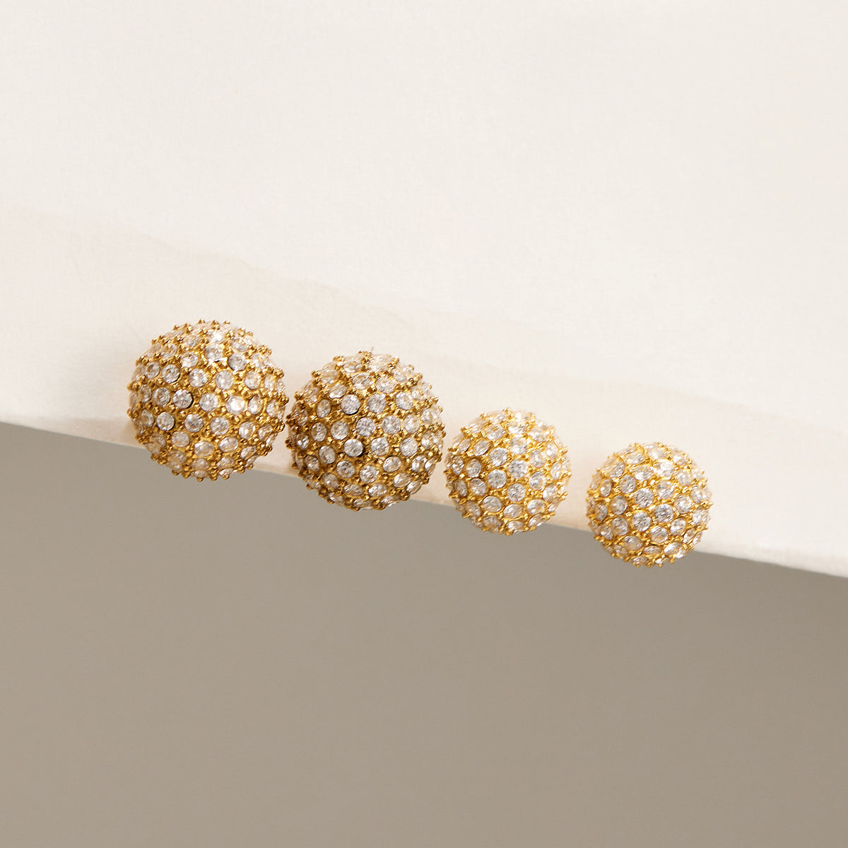 Pavé zircon ball stud earrings in matching gold-tone finish