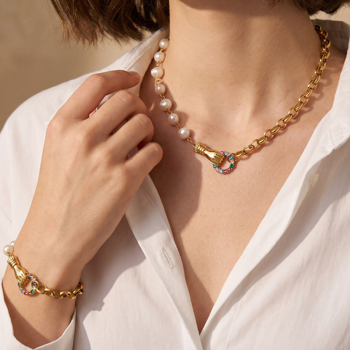 Freshwater pearl chain necklace styled with a matching gold bracelet on model