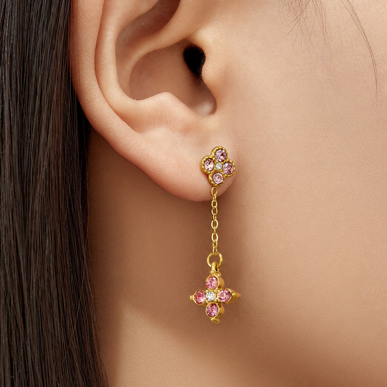 Model wearing pink cubic zirconia clover drop earrings in gold
