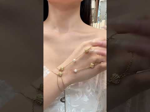 Gold shell zircon hand chain bracelet for women with pearl detail in stainless steel
