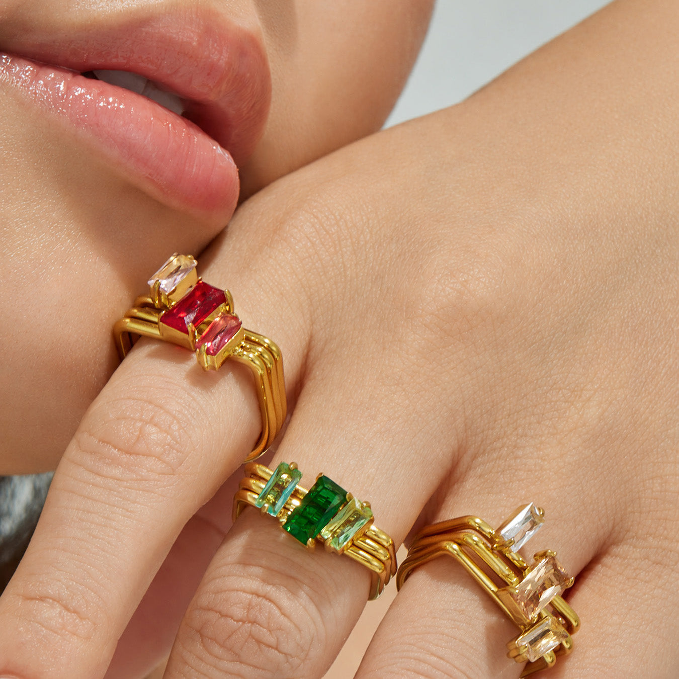 Model wearing red and green rectangular CZ multi-band rings in 316L stainless steel