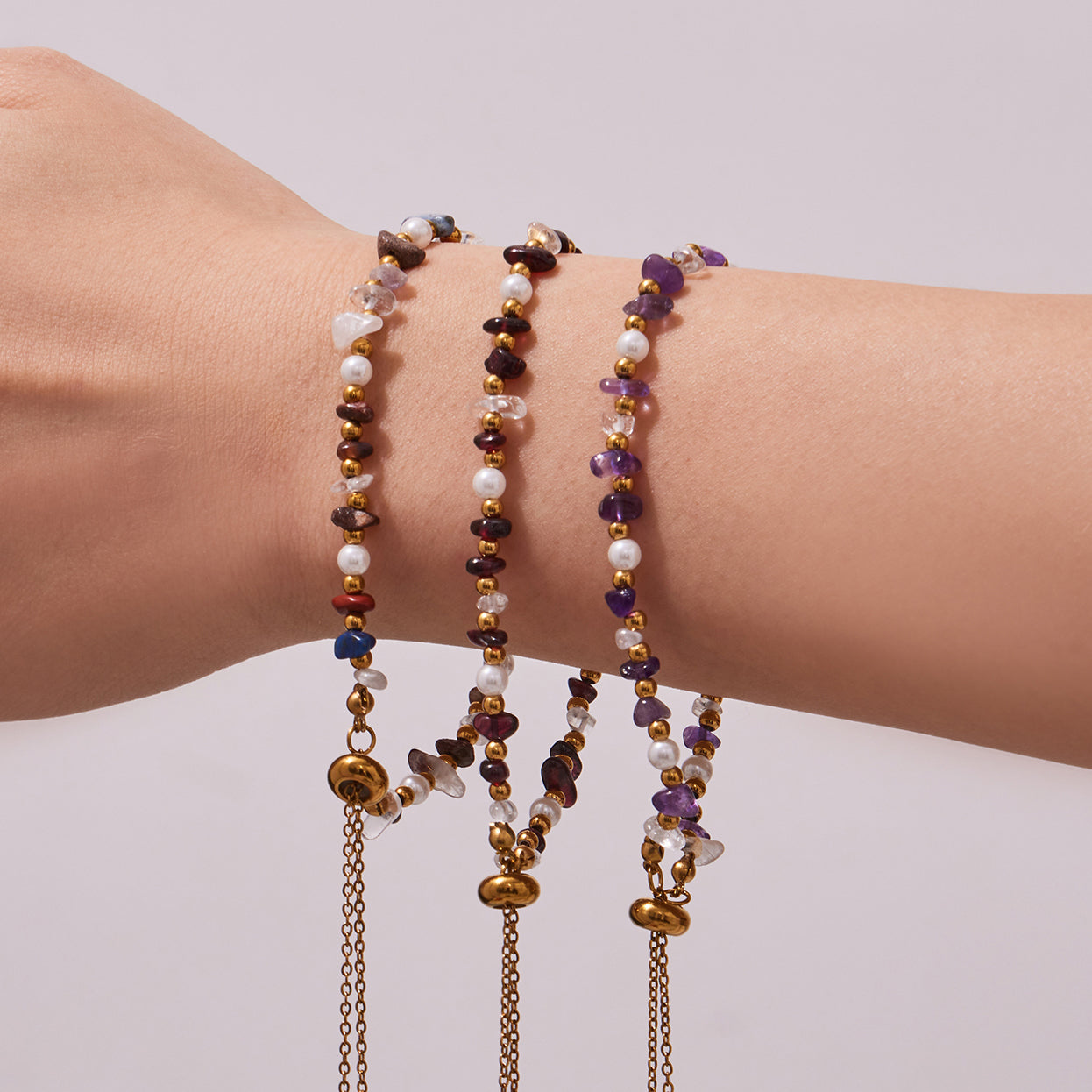 Stacked natural stone bracelets with pearl accents and adjustable extender chains