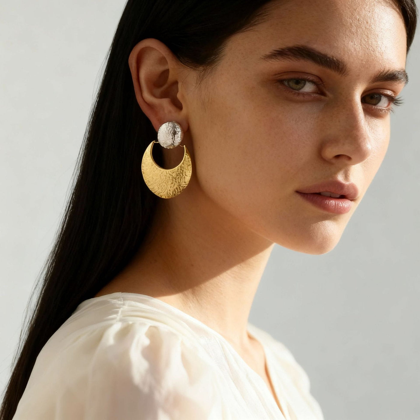 Model showcasing elegant tarnish-free 316L stainless steel hammered crescent hypoallergenic earrings.