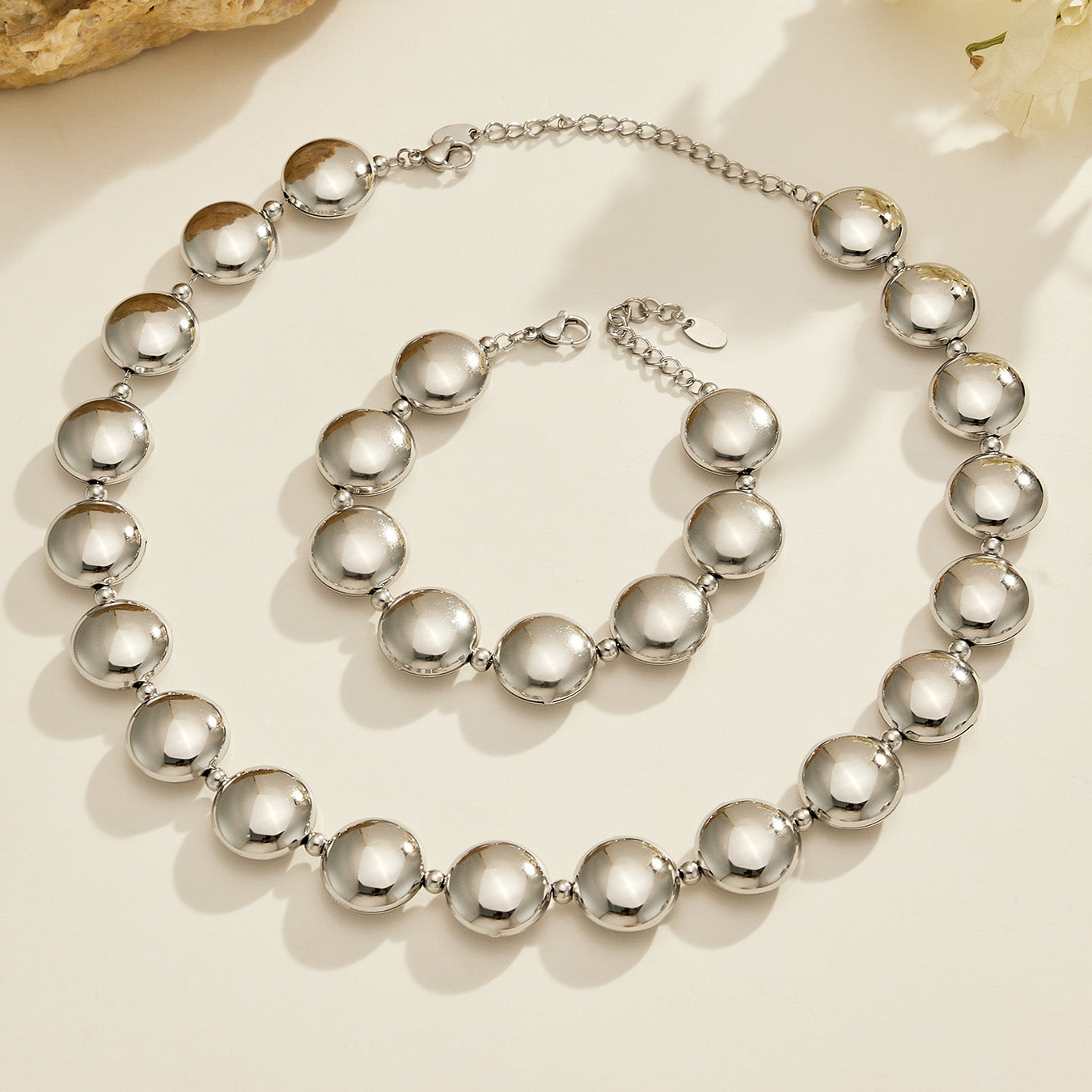 316L stainless steel flat bead necklace and bracelet set in polished steel, displayed together