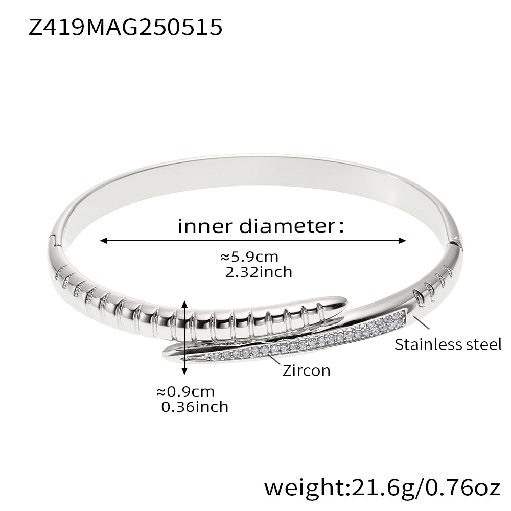 Steel-tone pink zircon nail bangle with a 5.9 cm inner diameter and 21.6 g weight