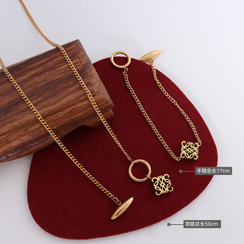 Gold-tone toggle symbol necklace and matching bracelet length guide
