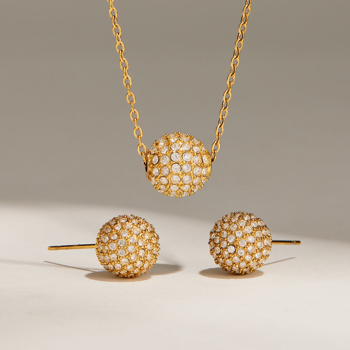 Matching zircon ball necklace and stud earrings in gold-tone stainless steel