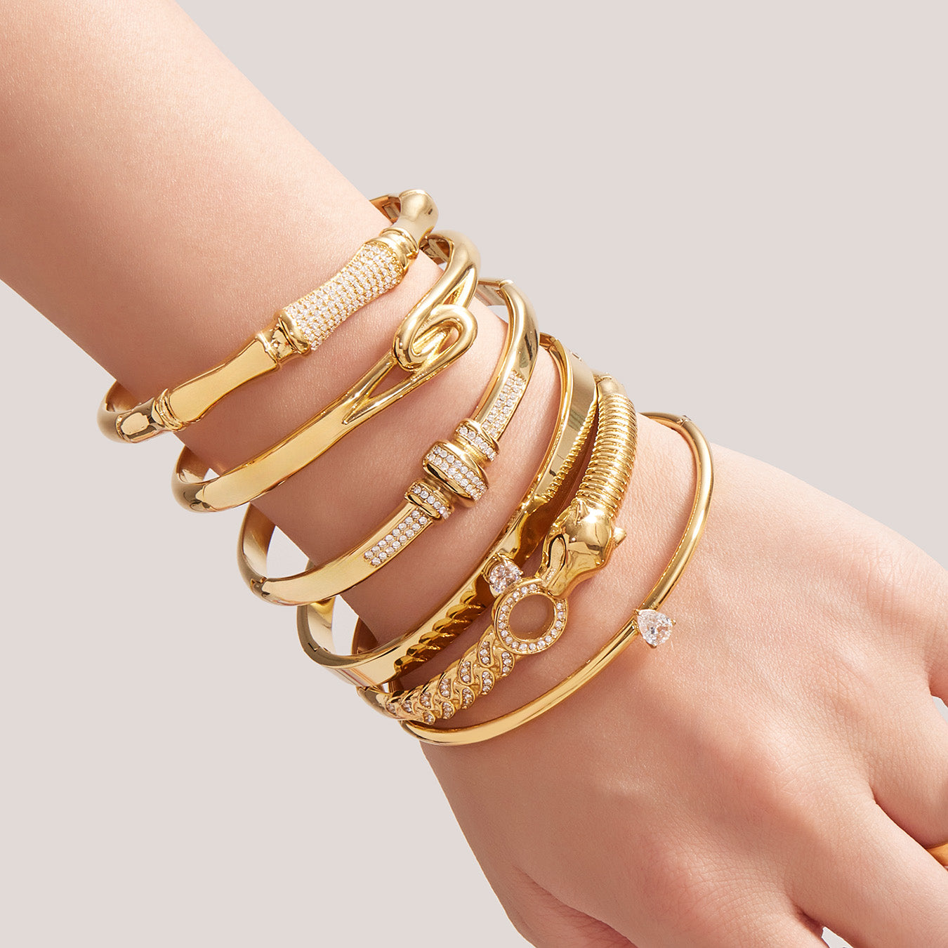 closeup of 18k gold 5a zircon bamboo bracelet set on wrist, minimalist fashion accessory