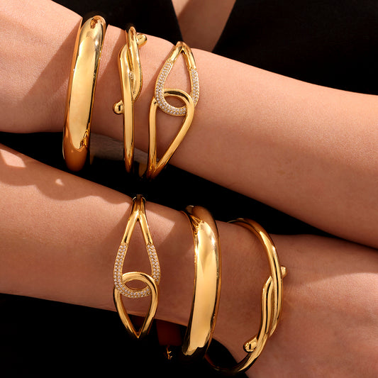 18K gold plated bangle set worn on both arms, elegant luxury style