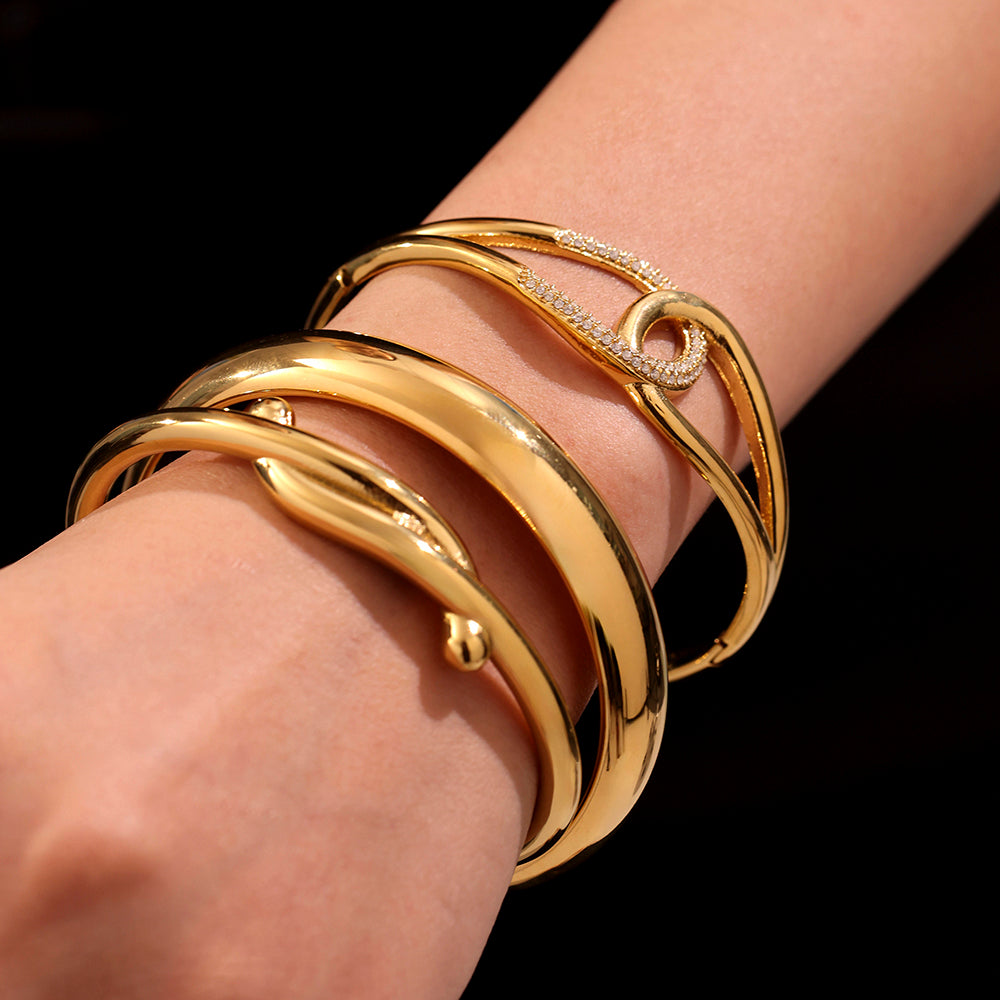 Closeup of 18K gold plated bangles stacked on wrist, sparkling zircon design