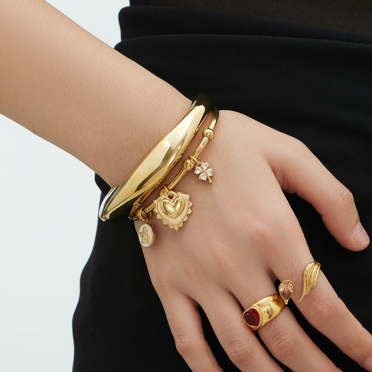 model wearing 18k gold c-shaped stainless steel bracelet set, layered fashion style