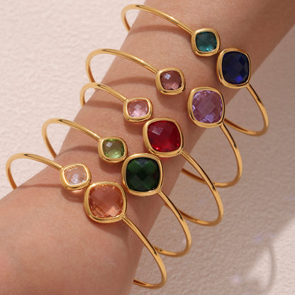 Model wearing multi-color 18k gold plated Czech glass stone open bangles, minimalist luxury jewelry