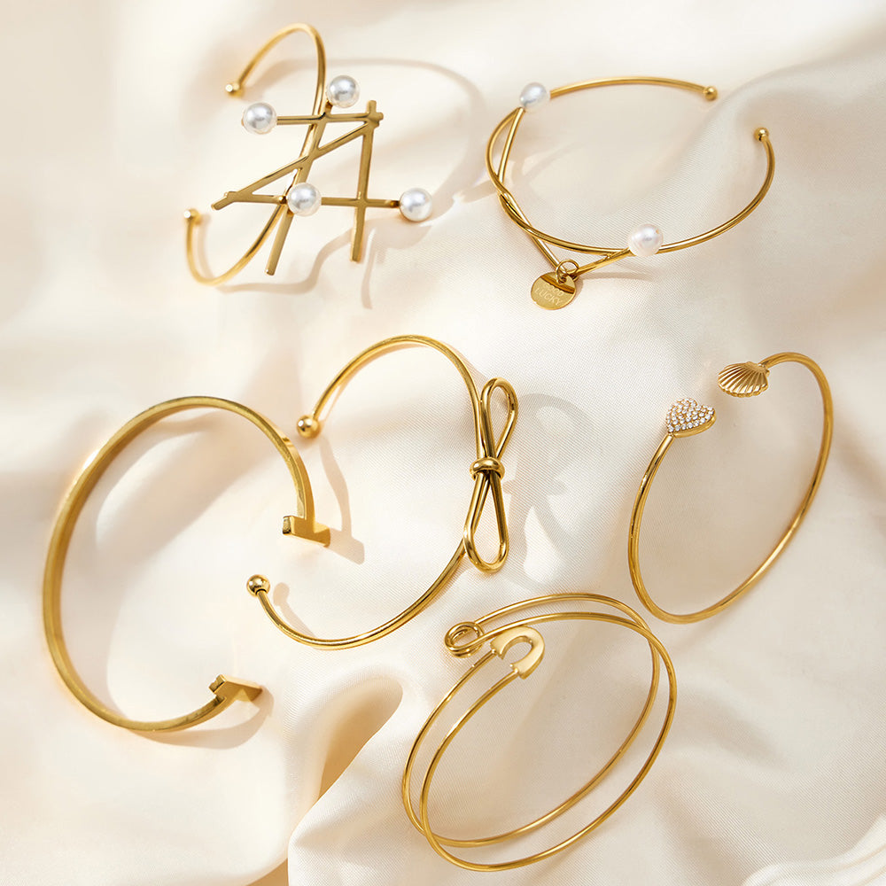 18K gold geometric line & pearl open bangle set displayed on silk, high-end fashion accessory