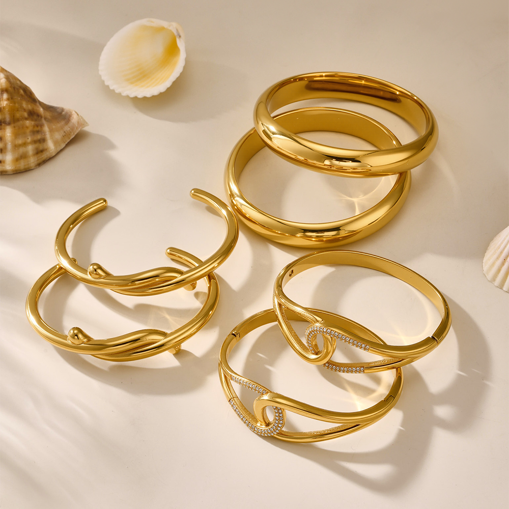 18K gold plated luxury bangle set displayed with seashells, wholesale high-end jewelry
