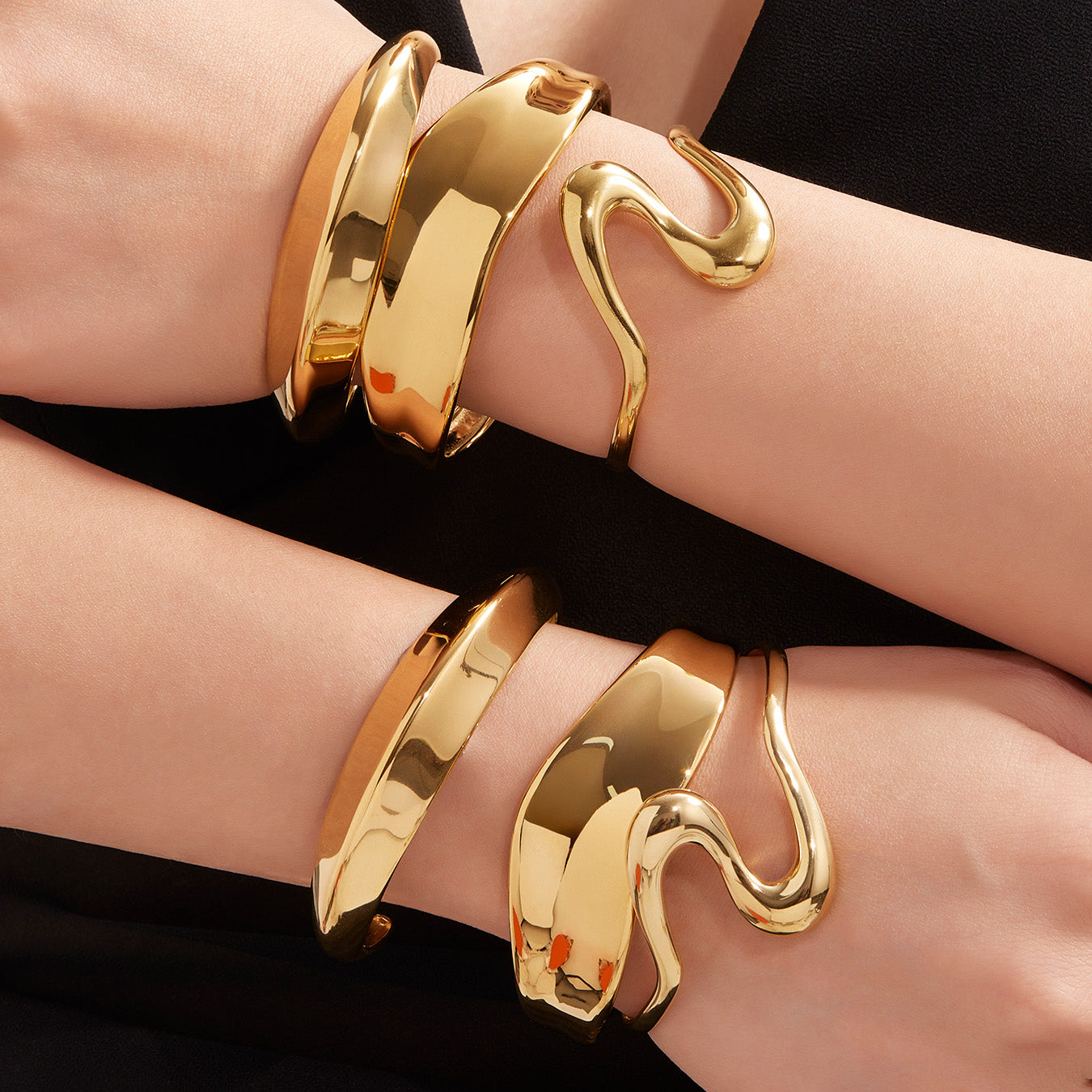 Model wearing 18k gold plated bold curved open bangle set, double wrist stacked