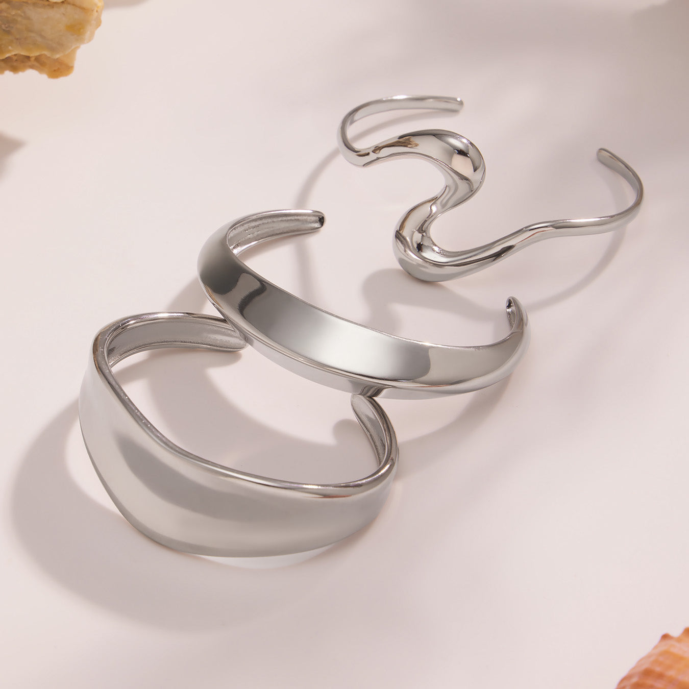 Silver 18k gold plated bold curved open bangle set, stacked on light background