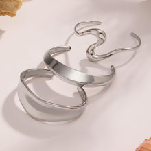 Silver 18k gold plated bold curved open bangle set, stacked on light background
