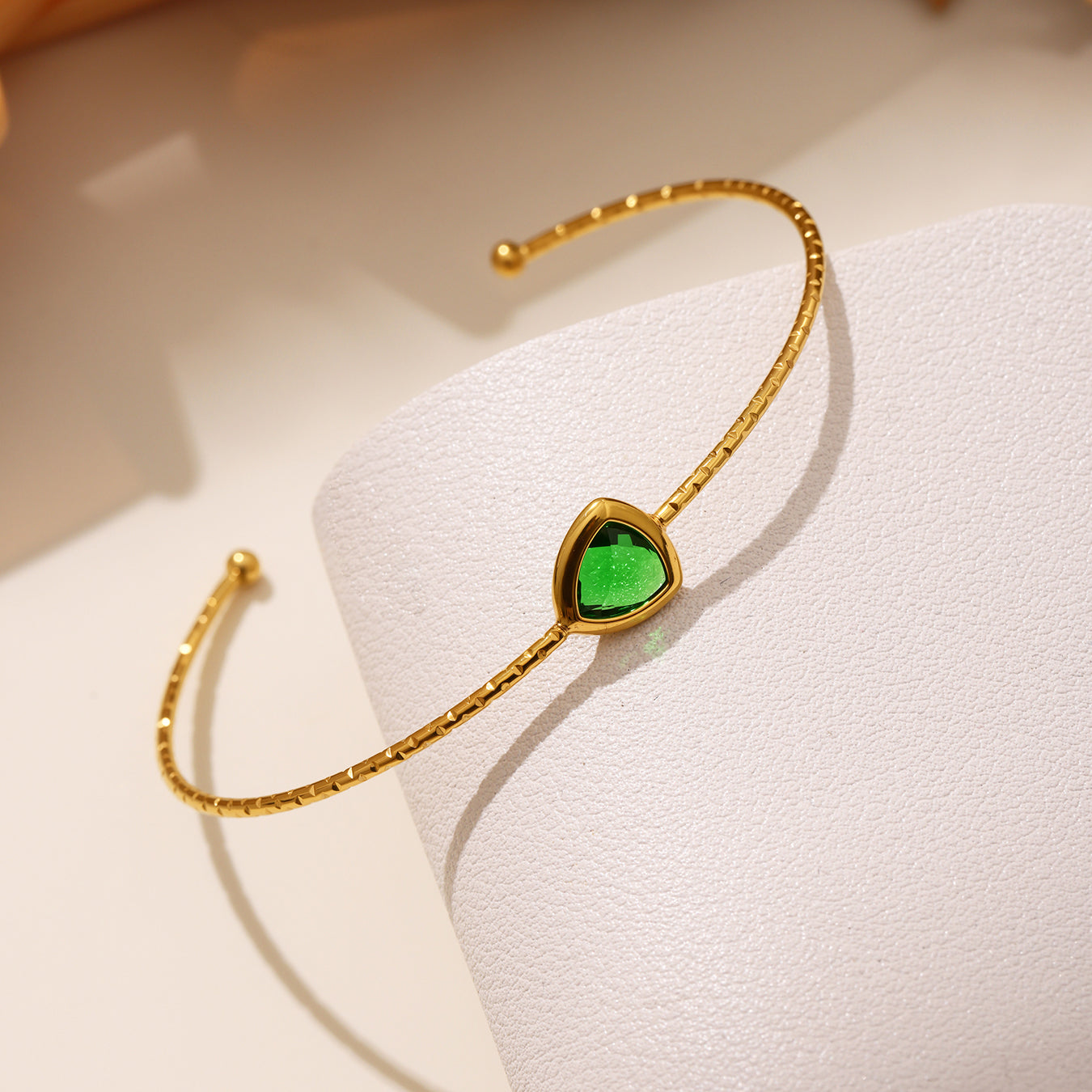 Green 18k gold plated cut Czech glass open bangle: sparkling faceted stone detail