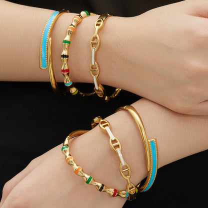 Model wearing 18k gold plated enamel clasp bangle set, double wrist stacked