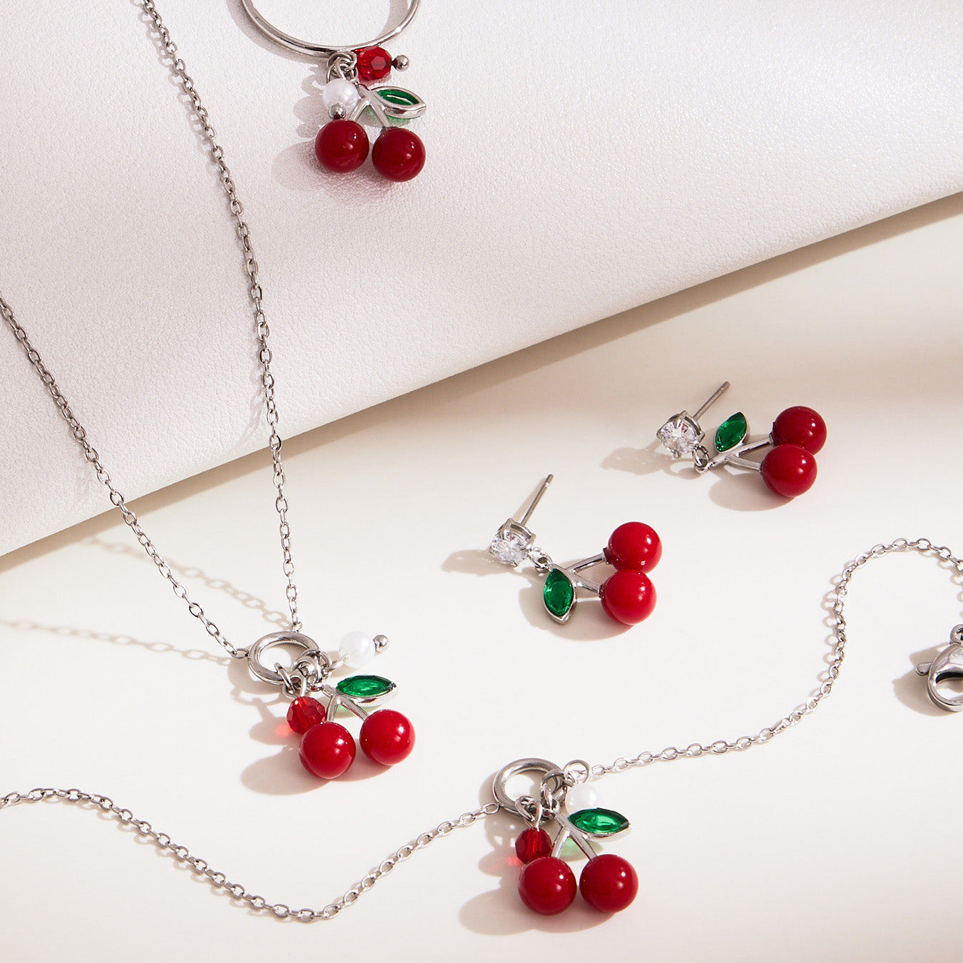 Silver 18k gold plated enamel red cherry jewelry set display on white background