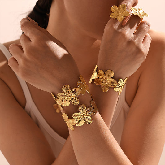 Closeup of 18k gold plated flower bangle and ring, 3D floral design