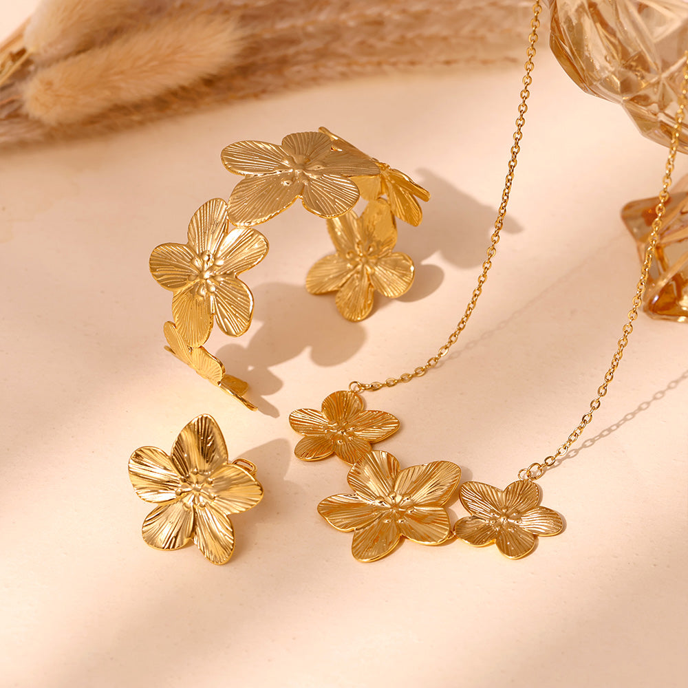 18k gold plated flower jewelry set display on light background