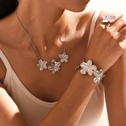Silver 18k gold plated flower jewelry set on model: ring, necklace, bangle