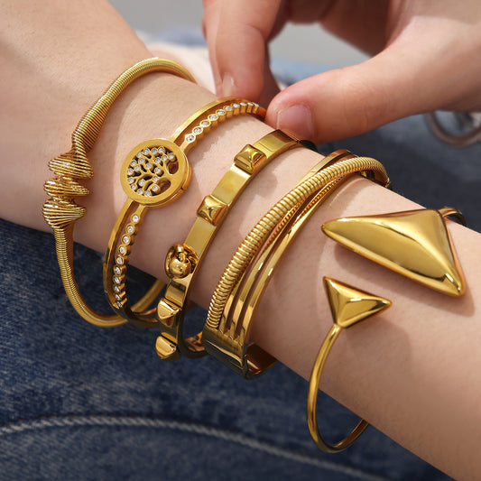 Closeup of 18k gold plated geometric open bangle set on wrist, irregular versatile design