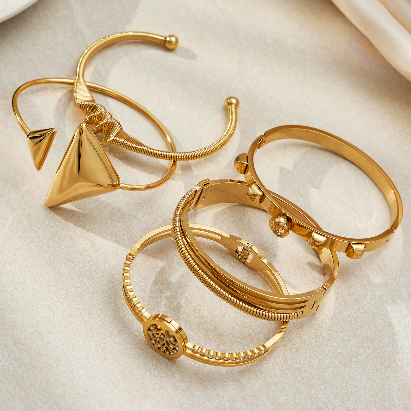 18k gold plated geometric open bangle set display on light background