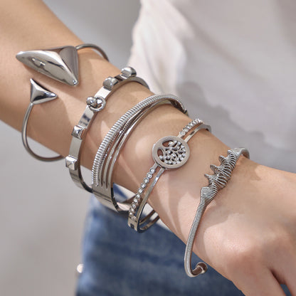 Silver 18k gold plated geometric open bangle set, stacked on model's wrist